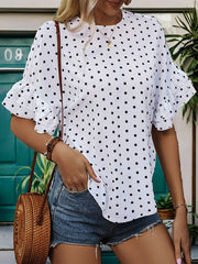 White polka dot blouse with ruffled sleeves and a keyhole neckline.
