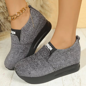 Gray textured round toe platform sneakers with black elastic trim and gold chain ankle accent.