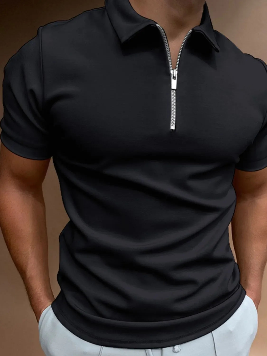 Black zip-front polo shirt with short sleeves and a streamlined fit.