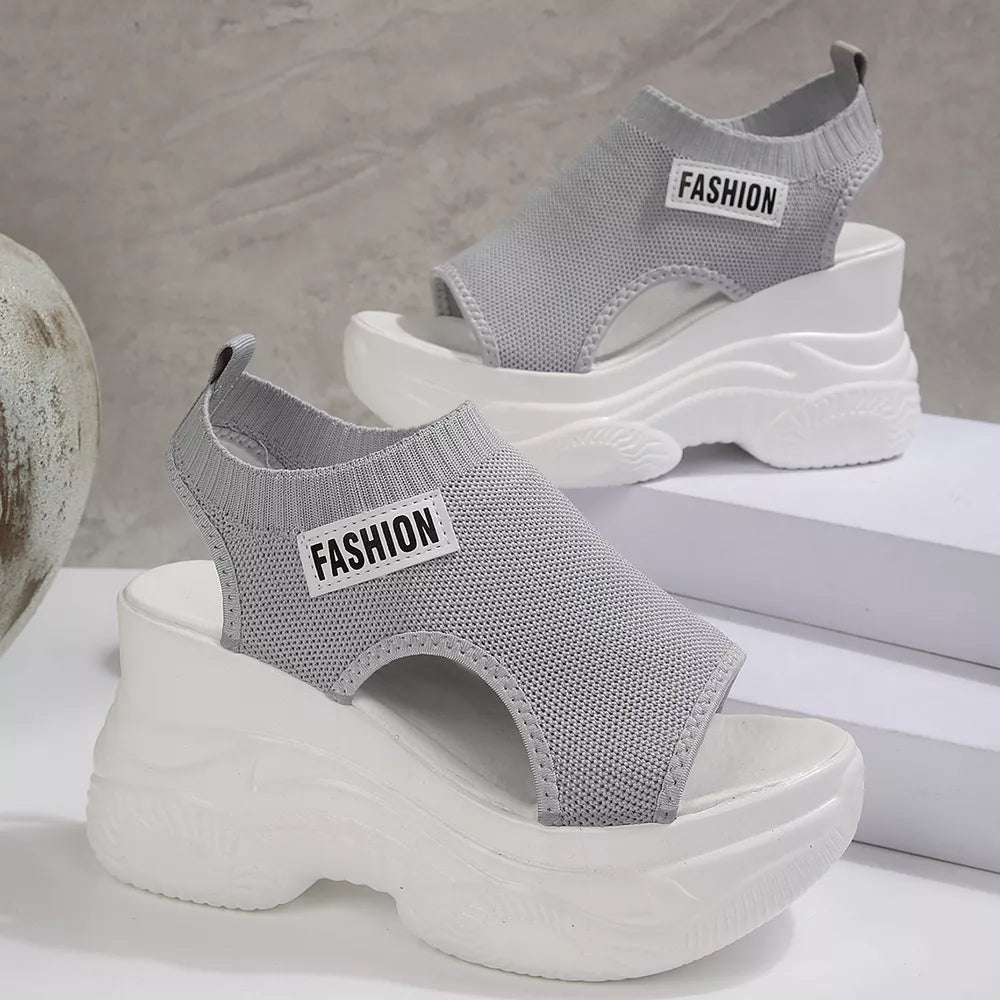 Fashion-forward gray open-toe wedge sandals with chunky white soles and "FASHION" detail.