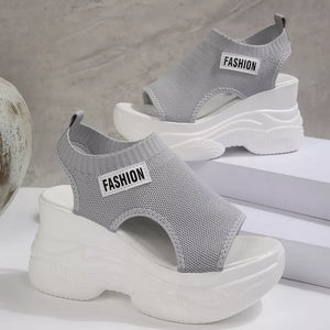 Fashion-forward gray open-toe wedge sandals with chunky white soles and "FASHION" detail.