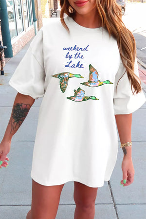 White cotton oversized tee with a graphic of flying ducks and text that reads "weekend by the Lake".