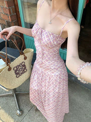 Ruched tied maxi dress in pink and white plaid, with spaghetti straps and a sweetheart neckline.