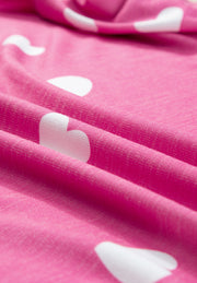 Hot pink pajama top with white heart pattern, soft knit fabric detail.