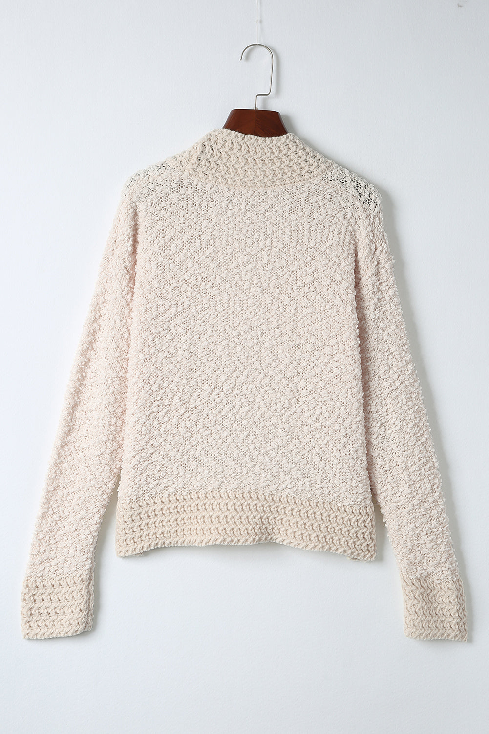 Cream textured bouclé open-front jacket with long sleeves and ribbed cuffs.