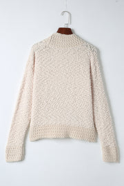 Cream textured bouclé open-front jacket with long sleeves and ribbed cuffs.