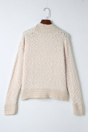 Cream textured bouclé open-front jacket with long sleeves and ribbed cuffs.