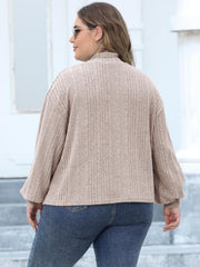 Beige ribbed knit sweater with mock neck and balloon sleeves.