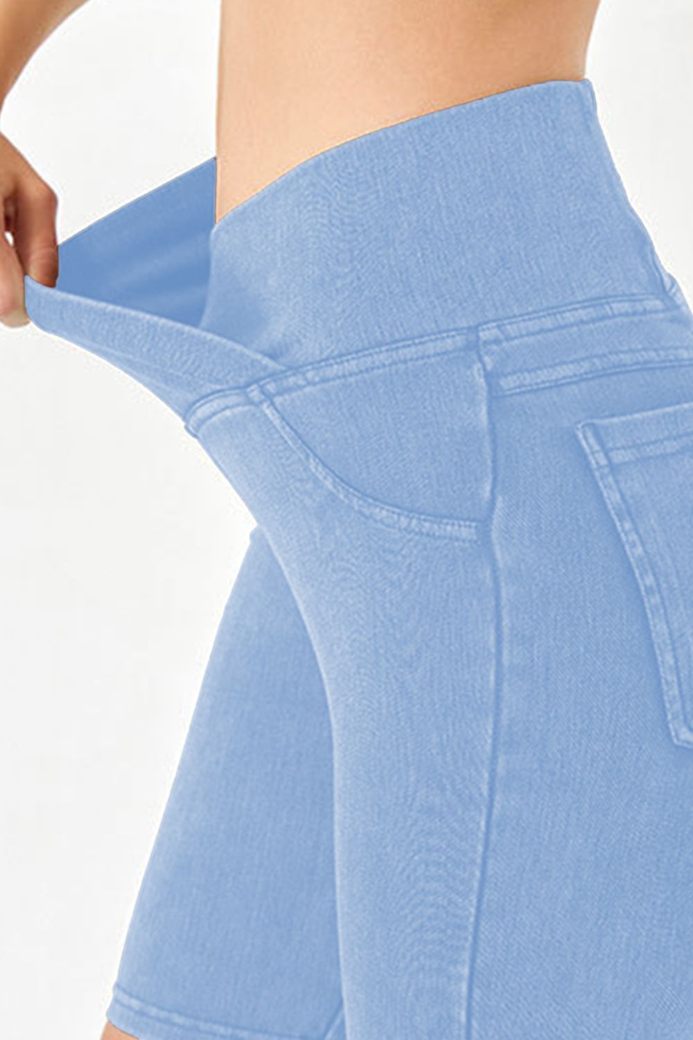 Peacock Blue denim bermuda shorts with a crisscross waistband detail.
