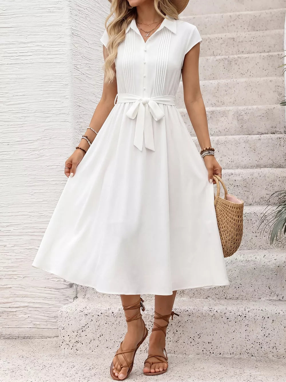 White midi dress with cap sleeves, button front, tie waist, and pleated bodice.
