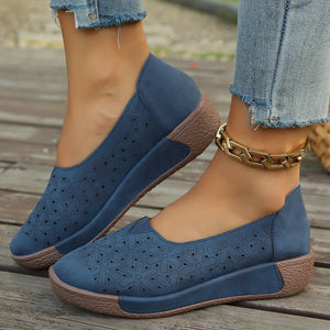 Blue floral cutout slip-on loafers with comfortable wedge sole.