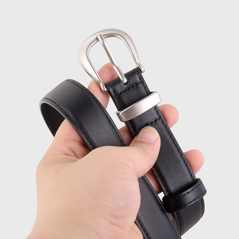 Black leather belt with silver buckle and keeper loop, showing detail of stitching.