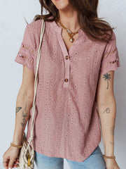Pink eyelet embroidered short-sleeve blouse with button-down neckline and cutout details.