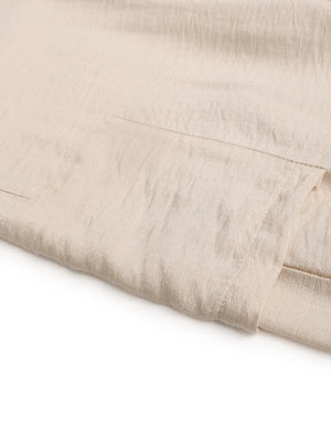 Chic waist-tie flare trousers in tan, showing pocket detail and textured fabric.