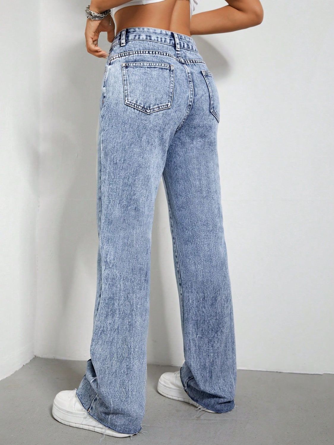 Light acid wash bootcut jeans with split hem detail