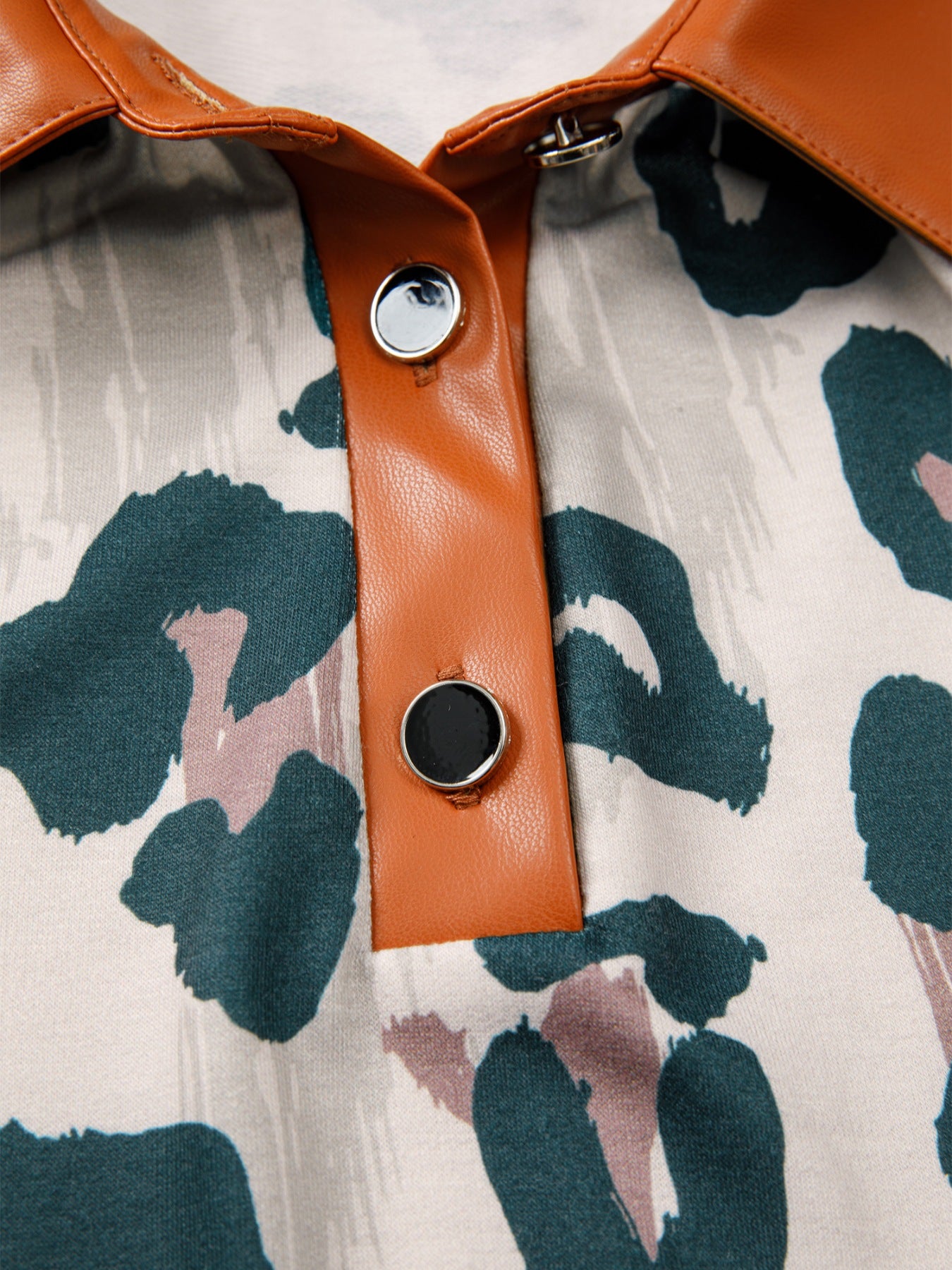 Print short sleeve blouse with brown faux leather collar and button placket, featuring an animal print.