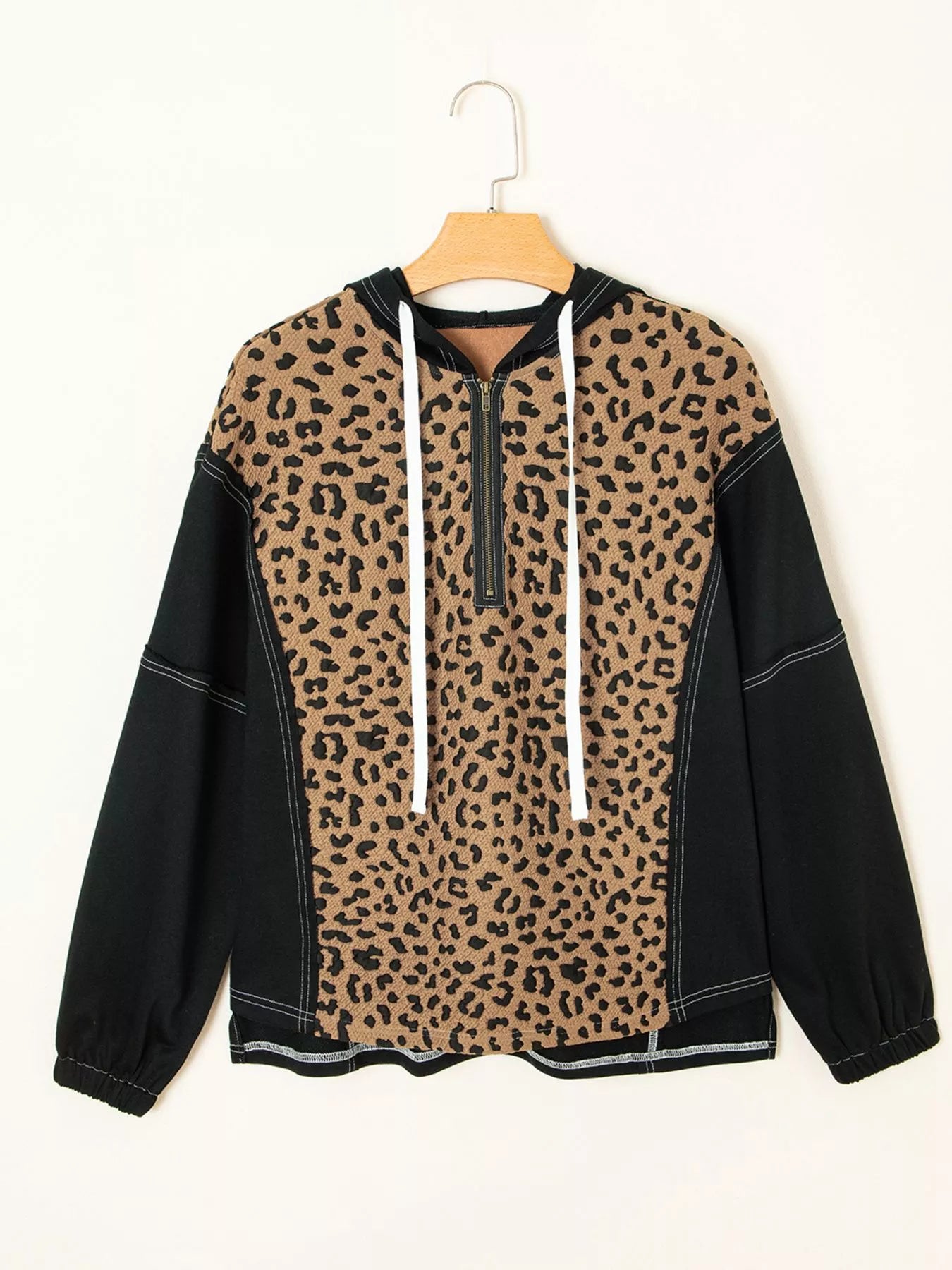Leopard print zip hoodie with black sleeves and white drawstrings.