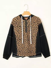 Leopard print zip hoodie with black sleeves and white drawstrings.