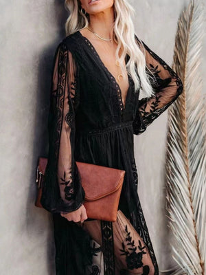 Black floral lace maxi dress with plunging neckline, long bell sleeves, and a thigh-high slit.