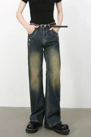 Faded wash dark bootcut jeans with button details and a belt.