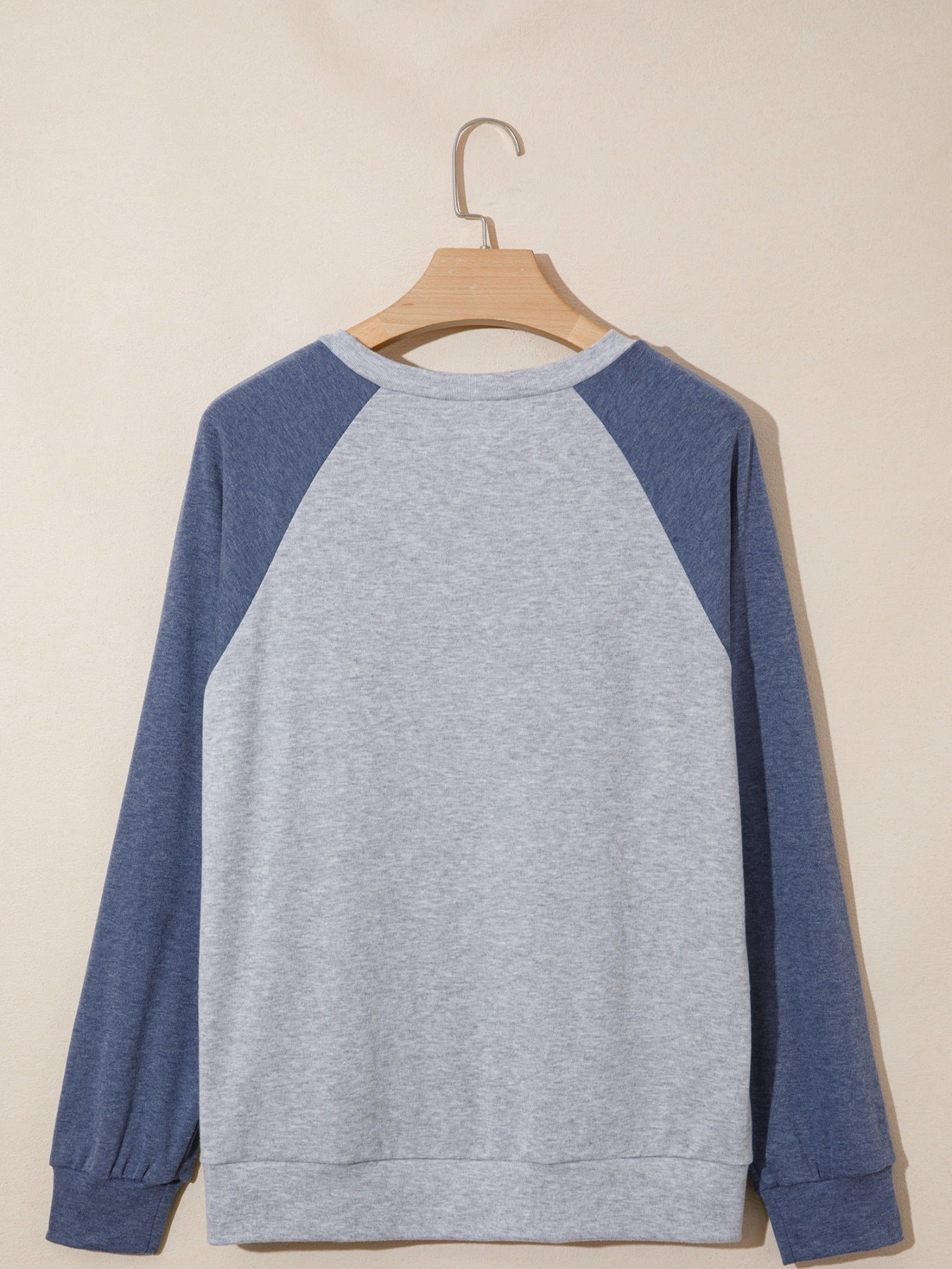 Raglan sleeve shirt in grey and blue with crew neck and cuffed sleeves.