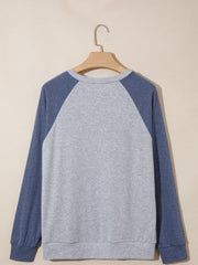 Raglan sleeve shirt in grey and blue with crew neck and cuffed sleeves.