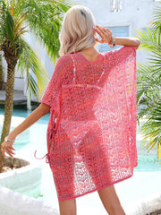 Lace-knit kaftan in hot pink with side tie detail, open knit pattern, v-neck, and short sleeves.