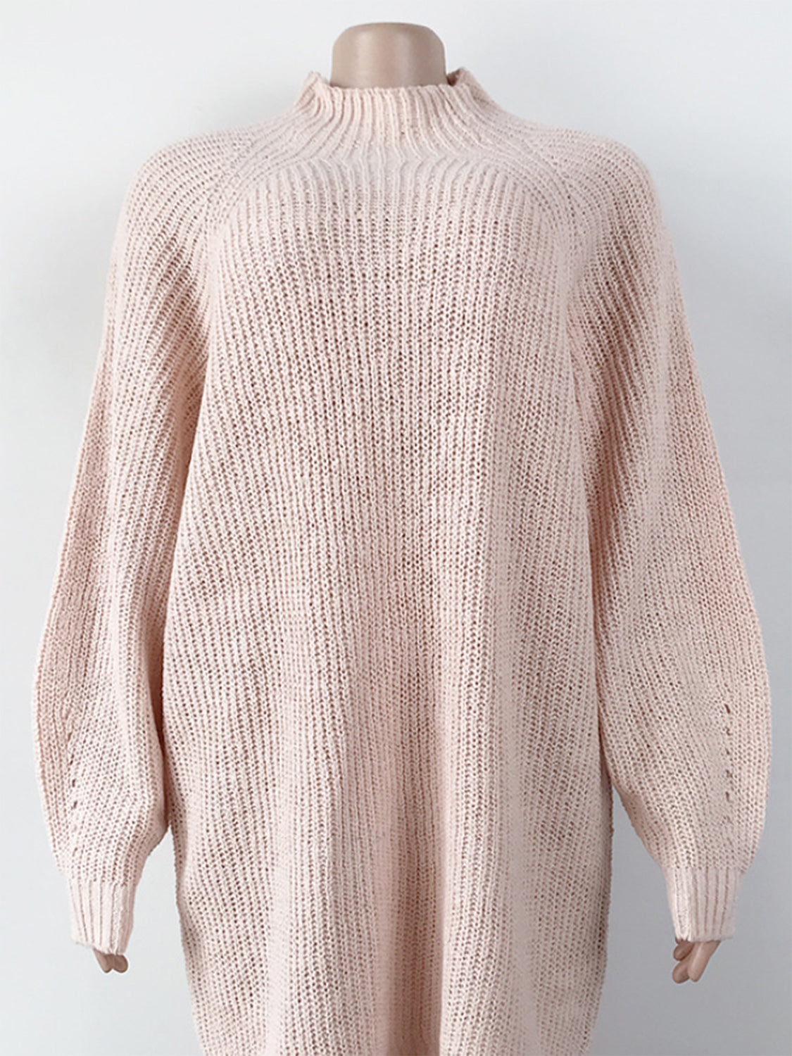 Blush pink ribbed knit cocoon turtleneck dress with long sleeves and a relaxed fit.
