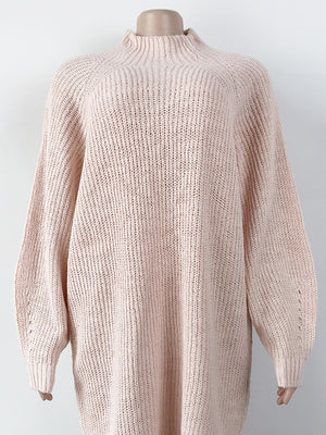 Blush pink ribbed knit cocoon turtleneck dress with long sleeves and a relaxed fit.