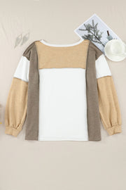 Colorblock knit top in tan, white, and brown with seam details and long sleeves.