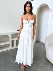 White backless maxi dress with spaghetti straps and a tie-front detail.