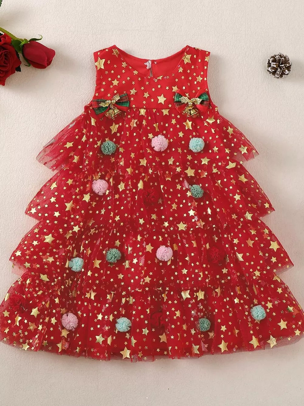 Red star print tulle baby dress with tiered skirt and pom-poms