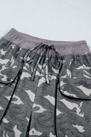Camouflage barrel pants with cargo pockets, drawstring waist, and ribbed waistband.
