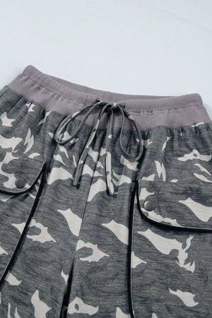 Camouflage barrel pants with cargo pockets, drawstring waist, and ribbed waistband.