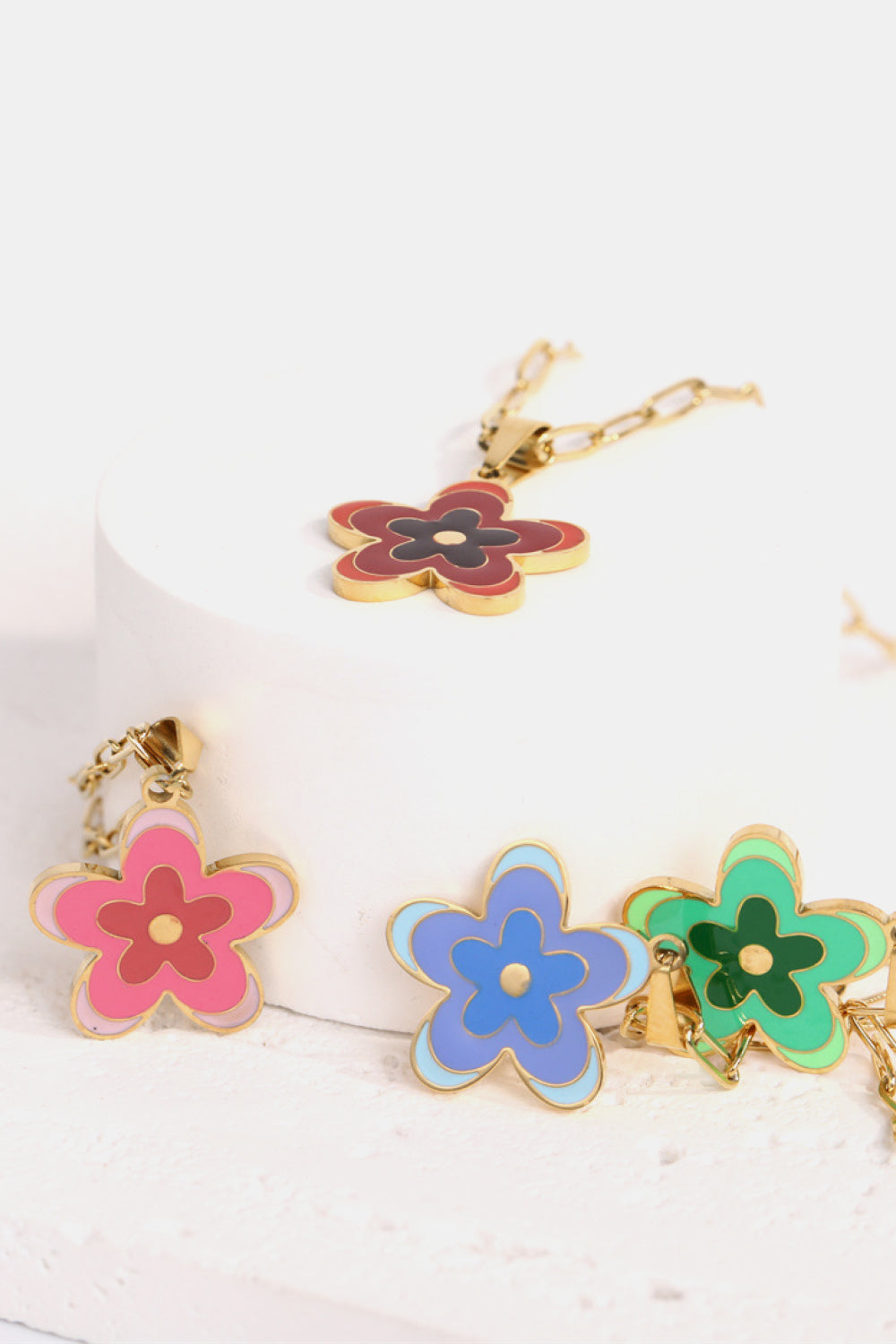 Enamel floral pendant chain necklace in red, pink, blue, and green on a gold-plated chain.