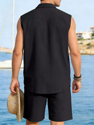 Men's black sleeveless linen shirt and shorts set, holding straw hat.