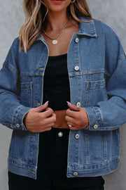 Oversized washed black denim trucker jacket with button front and chest pockets.