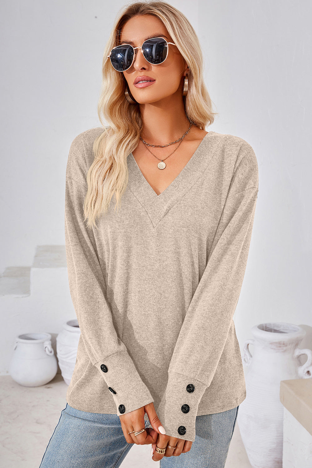 Cream V-neck long sleeve top with button cuffs