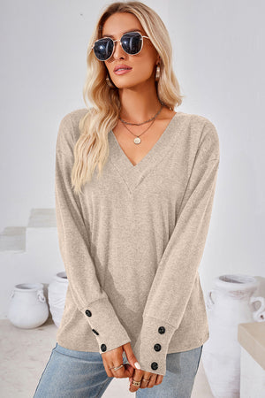 Cream V-neck long sleeve top with button cuffs