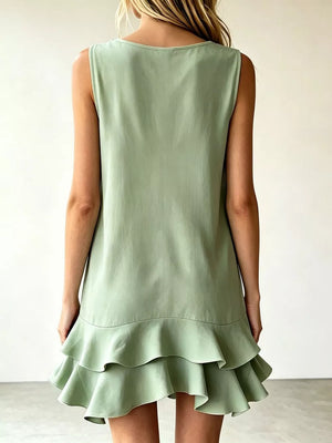 Light green tiered ruffle mini dress with a scoop neck and sleeveless design.