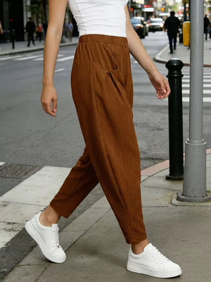 Camel harem pants with pockets and elastic waist, styled with white sneakers.