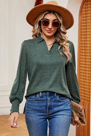 Dark green buttoned blouse with collared V-neck and lantern sleeves.