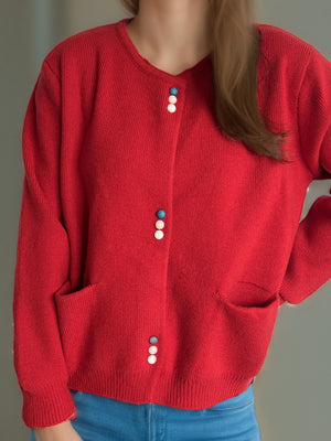 Scarlet ribbed knit button-up cardigan with playful pastel buttons and pockets.