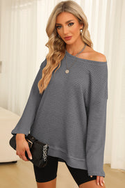 Charcoal waffle knit oversized top with slit hem and off-the-shoulder neckline.