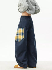 Navy blue wide-leg sweatpants with plaid patchwork pocket detail.
