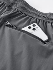 Gray sweatpants with zippered pocket holding a smartphone.