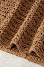 Textured brown knit pullover sweater with wide bell sleeves and a chunky knit pattern.