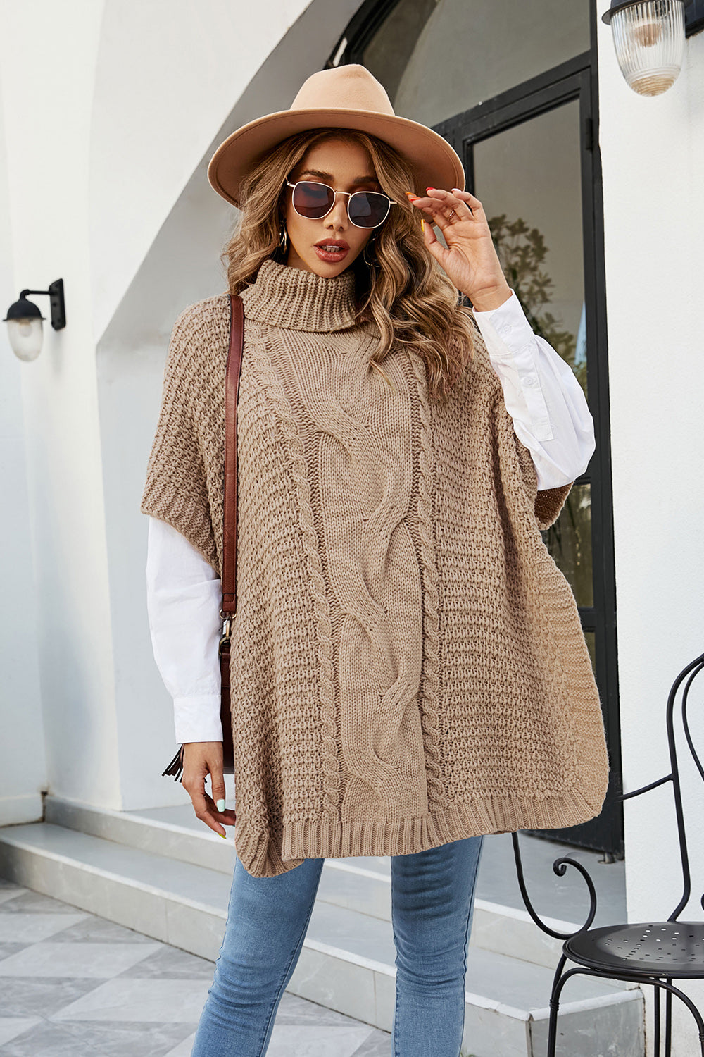 Camel cable knit turtleneck poncho with side slit, acrylic.