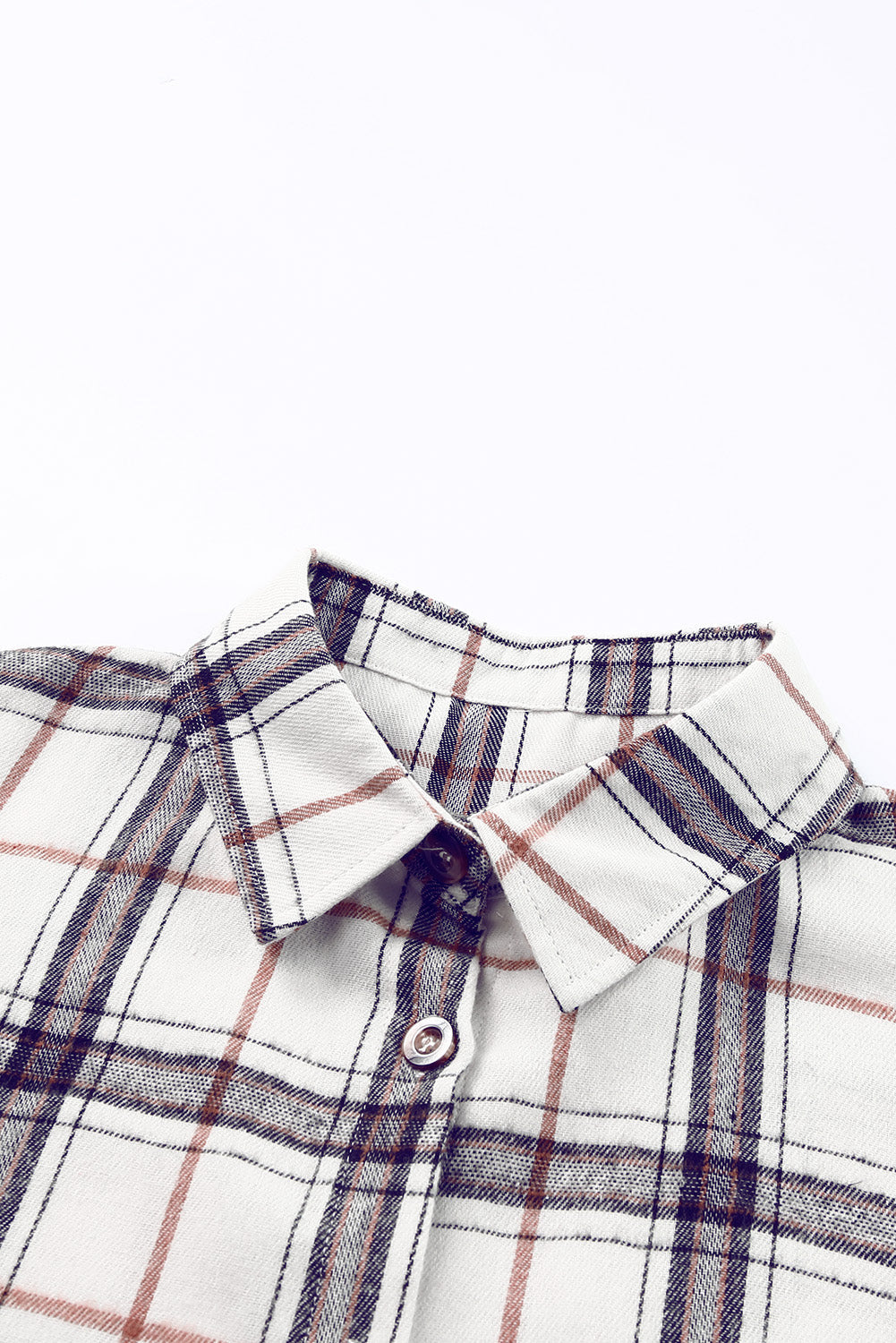 Oversized shacket with white, navy, and rust plaid pattern, featuring a collared neckline and button detail.