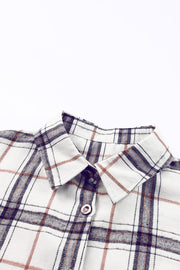 Oversized shacket with white, navy, and rust plaid pattern, featuring a collared neckline and button detail.